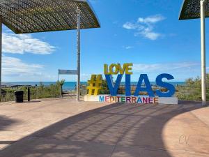 a sign that reads love was modifiederate at the beach at Maison "Havre de Paix" dans résidence avec piscine in Vias