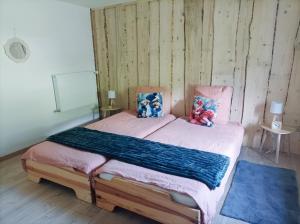 a bedroom with a bed with two pillows on it at Le refuge de la source in Bussang