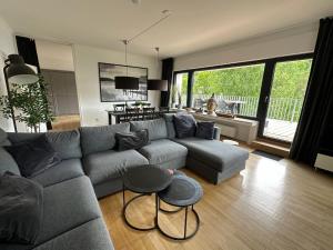 a living room with a couch and a table at Villa Holgenbach - Penthouse- und Ferienwohnung im Nationalpark Eifel in Schleiden