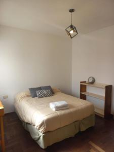 a bedroom with a bed and a table with a lamp at PH La Plata Casco Urbano in La Plata +12 photos