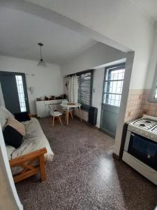 a living room with a couch and a stove at PH La Plata Casco Urbano in La Plata