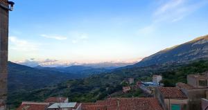 a view of a valley with mountains and buildings at Casa Bainsizza in Isnello