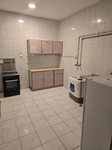 a kitchen with a stove and a refrigerator in it at ملاذ للشقق المفروشة 2 in Tabuk +11 photos