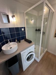 a bathroom with a washing machine and a sink at Appartement quartier des Minimes avec piscine, parking, en bordure du port à La Rochelle in La Rochelle +16 photos