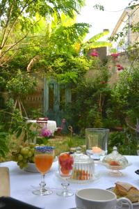 a table with glasses and plates of food on it at la maison, chambre d'hôtes de charme et atelier d'artiste, Libourne saint Emilion in Libourne