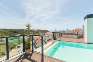 a swimming pool on the balcony of a house at Stunning Coastal Retreat - Two-Bedroom Apartment in Zambujeira do Mar in Zambujeira do Mar