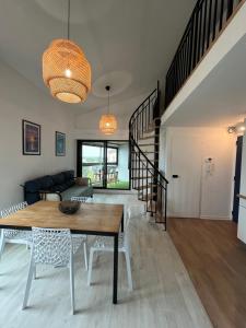 a living room with a table and a couch at Appartement quartier des Minimes avec piscine, parking, en bordure du port à La Rochelle in La Rochelle