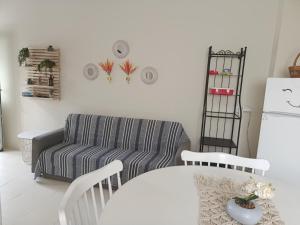 a living room with a couch and a table at Cavo Prima Kiotari in Gennadi