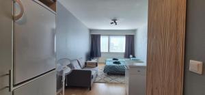 a small living room with a couch and a table at Comfortable studio close to Oulu center, free parking in Oulu