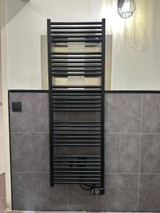 a black towel rack in a shower in a bathroom at Loft de la louve in Villeveyrac +25 photos