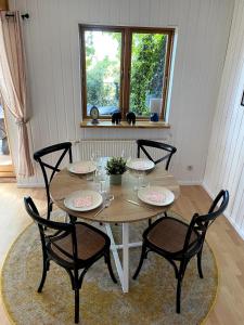 a wooden table with four chairs and a table with wine glasses at Uferglück Plau - mit eigenem Seezugang in Plau am See +24 photos