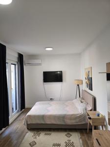 Postel nebo postele na pokoji v ubytování Kmb Apartment