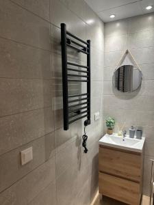 a bathroom with a sink and a mirror at Apartamento Vinoble Jerez in Jerez de la Frontera +20 photos