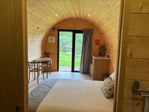 a room with a bed and a table and a kitchen at Gerês Wood Valley in Geres +103 photos