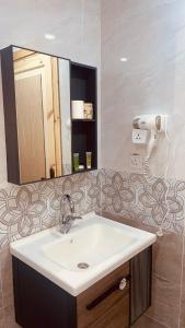 a bathroom with a sink and a mirror at Kylie magic camp in Wadi Rum