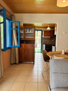 a kitchen with a table and a dining room at Sotirias Beach House in Kalamos