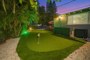 a yard with a putting green with a golf ball at La Playita 4-BR Heated Pool Miami 16 Guests in Miami