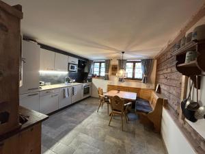 a kitchen with a table and chairs in a room at Linsingerhof in Achenkirch