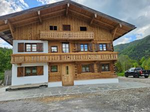 a large wooden house with a large front door at Linsingerhof in Achenkirch