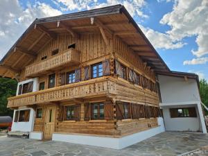 a large wooden building with a gambrel roof at Linsingerhof in Achenkirch