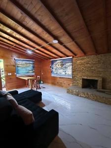 a living room with a fireplace and a flat screen tv at Nido y Mirador El Condor Sierra Nevada Guican y El Cocuy in Güicán