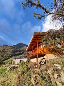 a wooden house on top of a hill at Nido y Mirador El Condor Sierra Nevada Guican y El Cocuy in Güicán