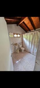 a bathroom with a toilet and a sink at La Miel in Barbosa