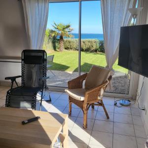 a living room with a view of the ocean at Reine de la plage in Fouesnant