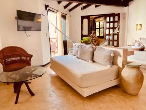 a living room with a couch and a table at Hotel Para Ti - Adults Only in Holbox Island