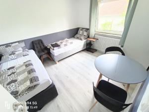 a room with a bed and a table and chairs at FMi21 in Hochheim am Main