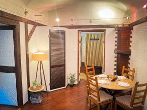 a dining room with a table and chairs at Apartament przy Starej Hucie in Szklarska Poręba