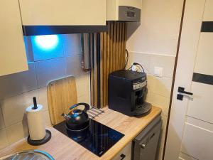 a small kitchen with a microwave on a counter at Apartament przy Starej Hucie in Szklarska Poręba +3 photos