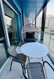 un tavolo con due sedie e un tavolo e sedie bianchi di Bucuria Studios Mamaia Nord a Mamaia Nord - Năvodari