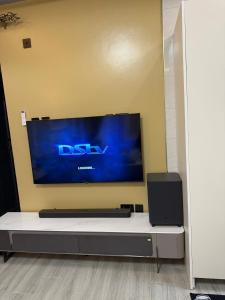 a flat screen tv sitting on a wall in a room at Mirembe housing in Nalakonge +5 photos