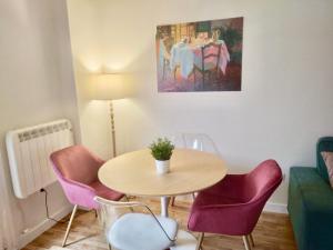 a living room with a table and chairs and a painting at Apartamento Casalarreina in Casalarreina
