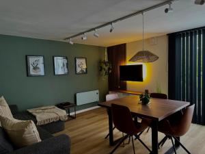 a living room with a table and a couch at Chez Denis et Jenni à Han sur Lesse in Han-sur-Lesse