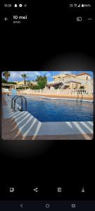 a picture of a building with a pool of water at Tranquilo Townhouse Casa Spain Kwintos in Torrevieja
