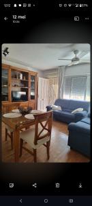 a living room with a table and a blue couch at Tranquilo Townhouse Casa Spain Kwintos in Torrevieja