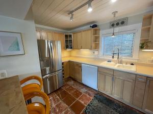 a kitchen with a stainless steel refrigerator and a sink at Rock Ridge lll Close to everything in Vero Beach