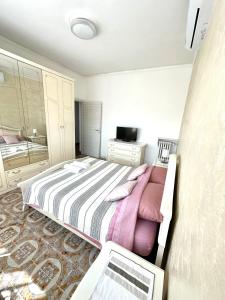 a bedroom with a bed and a laptop in it at Appartamento Vacanza Centro Asti in Asti