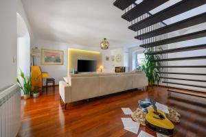 a living room with a couch and a table at Villa Serendipity Istria in Marčana