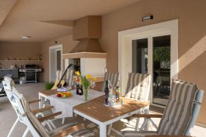 a dining room with a wooden table and chairs at Villa Serendipity Istria in Marčana