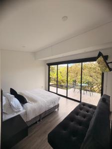 a bedroom with a large bed and a couch at Luxe Glamping in Moniquirá