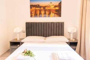a bedroom with a bed and a painting on the wall at LUXURY BABUINO -exclusive apartment in Rome