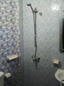 a shower stall in a bathroom with a sink at S I Appartements in Dakar