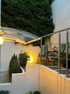 a patio with a table and an umbrella at Lovely Souterrain Apartment in Solingen