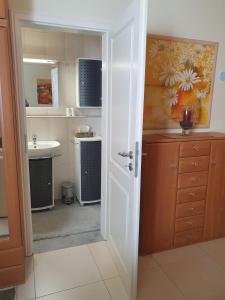 a small kitchen with a sink and a mirror at Lovely Souterrain Apartment in Solingen +15 photos