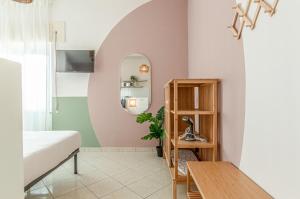 a bedroom with a bed and a mirror at Marenia Holiday Apartments and Rooms - mare e relax - in Lido di Latina  +276 photos