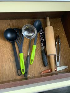 a drawer full of kitchen utensils on a table at Your Home 16 with parking in Myslava