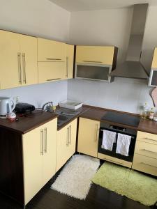 a kitchen with a sink and a stove top oven at Your Home 16 with parking in Myslava +10 photos